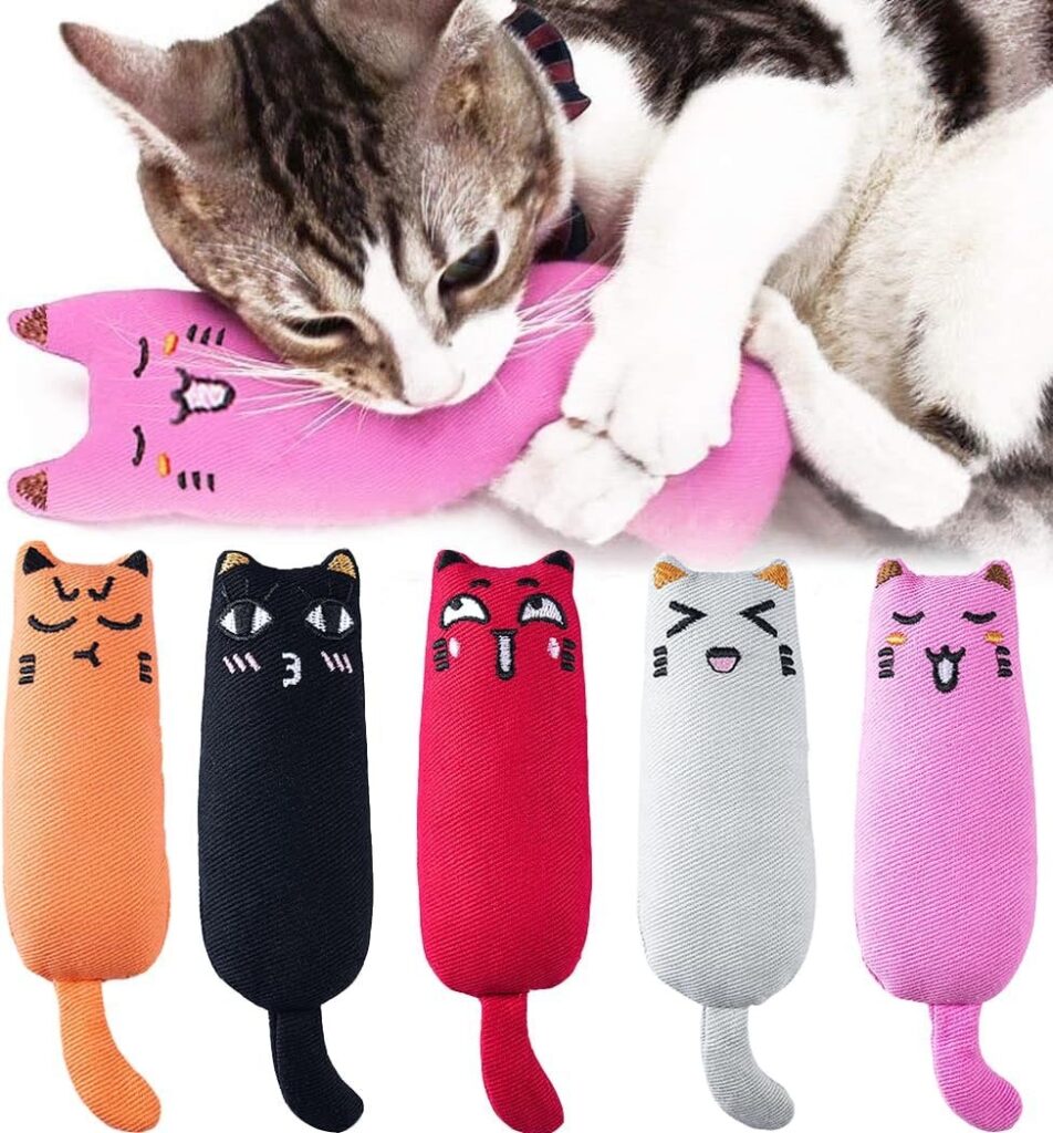 Leaving Your Cat Home Alone: What to Prepare Before You Travel Catnip toy with a cat biting and kicking a soft plush toy